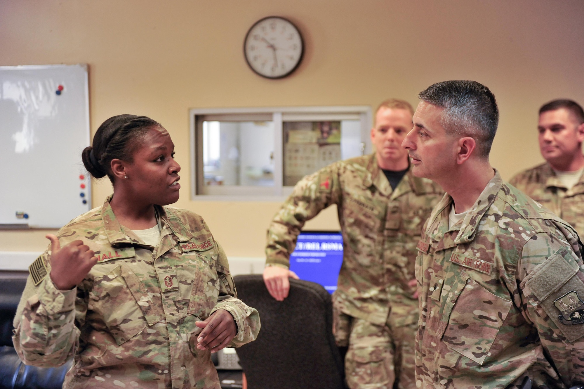U.S. Air Force Brig. Gen. Dave Julazadeh, 455th Air Expeditionary Wing commander, talks with an Airman assigned to the 451st Air Expeditionary Group at Kandahar Airfield, July 25, 2015. The general and Chief Master Sgt. Matt Grengs, 455th AEW command chief, met with Airmen from across the group who provide intelligence, surveillance and reconnaissance for U.S. and Coalition forces operating outside the wire while also operating one of the busiest airfields in the theater.  (U.S. Air Force photo by Maj. Tony Wickman/Released)