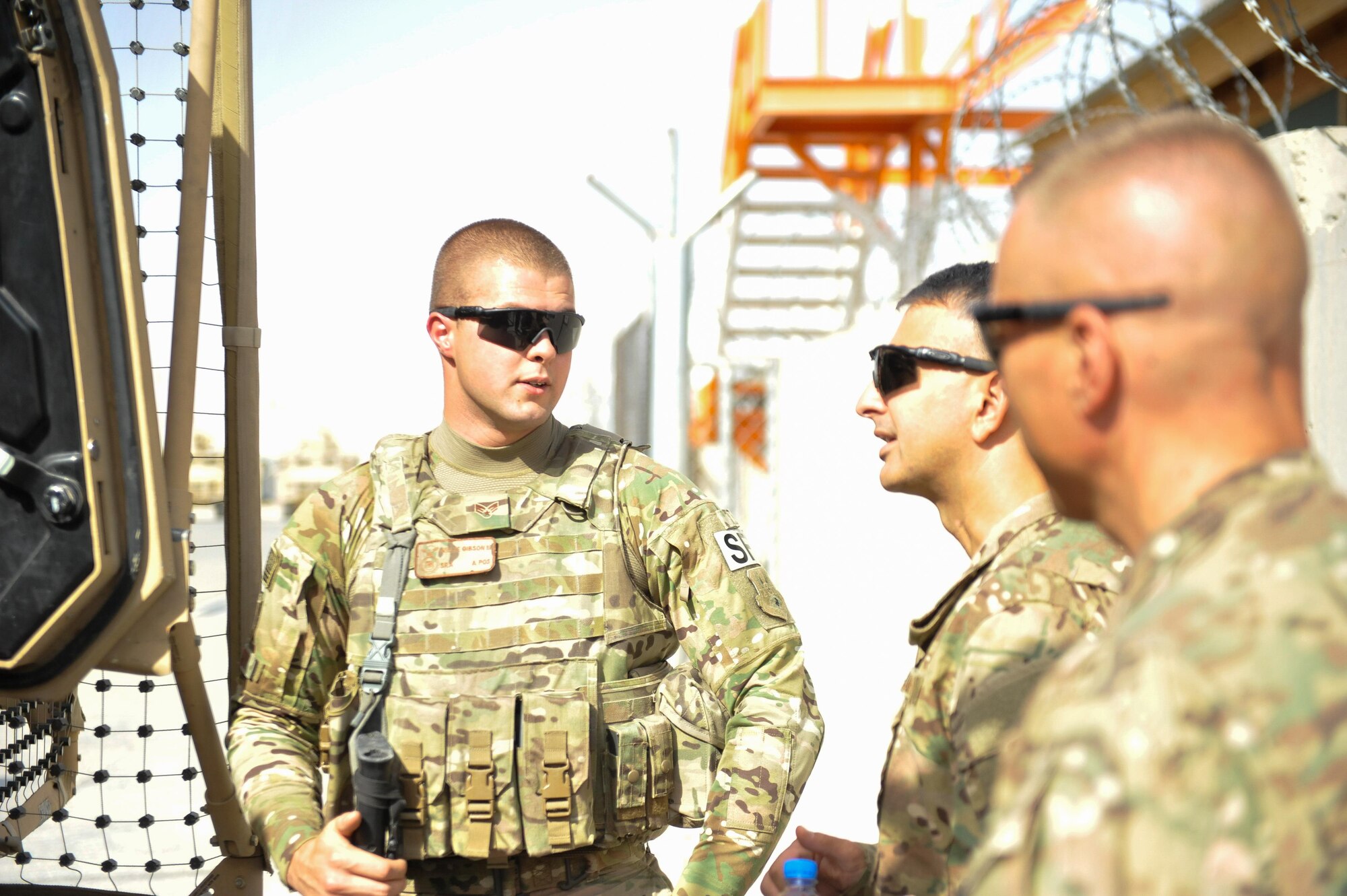 U.S. Air Force Brig. Gen. Dave Julazadeh, 455th Air Expeditionary Wing commander, and Chief Master Sgt. Matt Grengs, 455th AEW command chief talk with an Airman assigned to the 451st Air Expeditionary Group at Kandahar Airfield, July 24, 2015. The general and chief met with Airmen from across the group who provide intelligence, surveillance and reconnaissance for U.S. and Coalition forces operating outside the wire while also operating one of the busiest airfields in the theater.  (U.S. Air Force photo by Maj. Tony Wickman/Released)