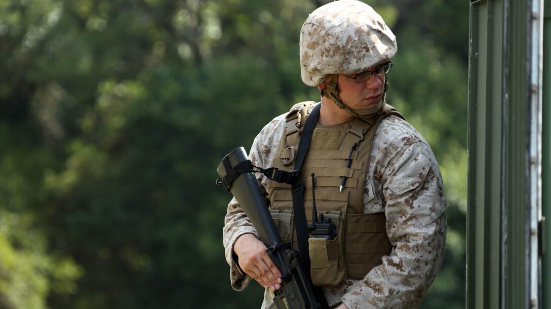 Lance Cpl. Erik Hedrick posts security during a training exercise at Marine Corps Auxiliary Landing Field Bogue, North Carolina, July 23, 2015. Marines with MWHS-2, Marine Wing Support Squadron 274 and Marine Wing Communications Squadron 28 gathered at the airfield for a training exercise to simulate a deployed environment. Hedrick is a special intelligence systems communicator with Marine Wing Headquarters Squadron 2.