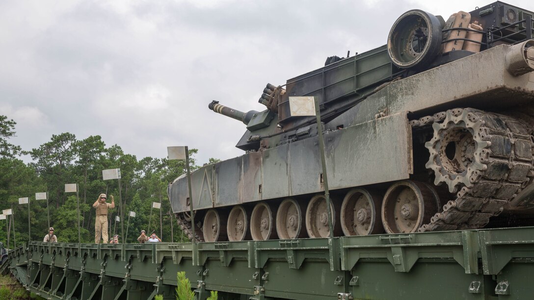 An M1A1 Abrams tank with 2nd Tank Battalion, 2nd Marine Division, crosses a medium girder bridge constructed by Marines with Bridge Company, 8th Engineer Support Battalion aboard Camp Lejeune, N.C., July 24, 2015. The bridge is designed to hold up to the weight of a tank, approximately 72 tons, and is an essential component in providing the Marine Expeditionary Forces with increased mobility. 