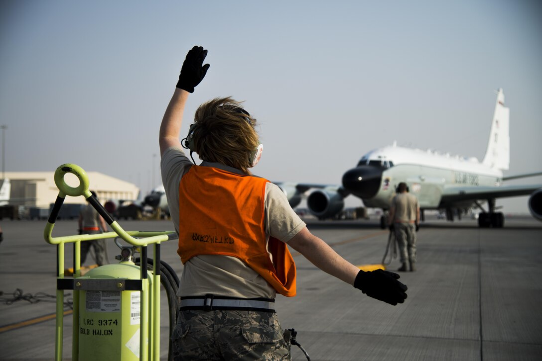 Members of the 379th Expeditionary Aircraft Maintenance Squadron marshal an RC-135 Rivet Joint surveillance aircraft into position July 24, 2015 at Al Udeid Air Base, Qatar. The RC-135 Rivet Joint aircraft has maintained a constant presence in Southwest Asia since the early 1990s. The aircraft and crew are deployed from Offutt Air Force Base, Neb. in support of Operation Inherent Resolve and Operation Freedom’s Sentinel. (U.S. Air Force photo by Tech. Sgt. Rasheen Douglas)