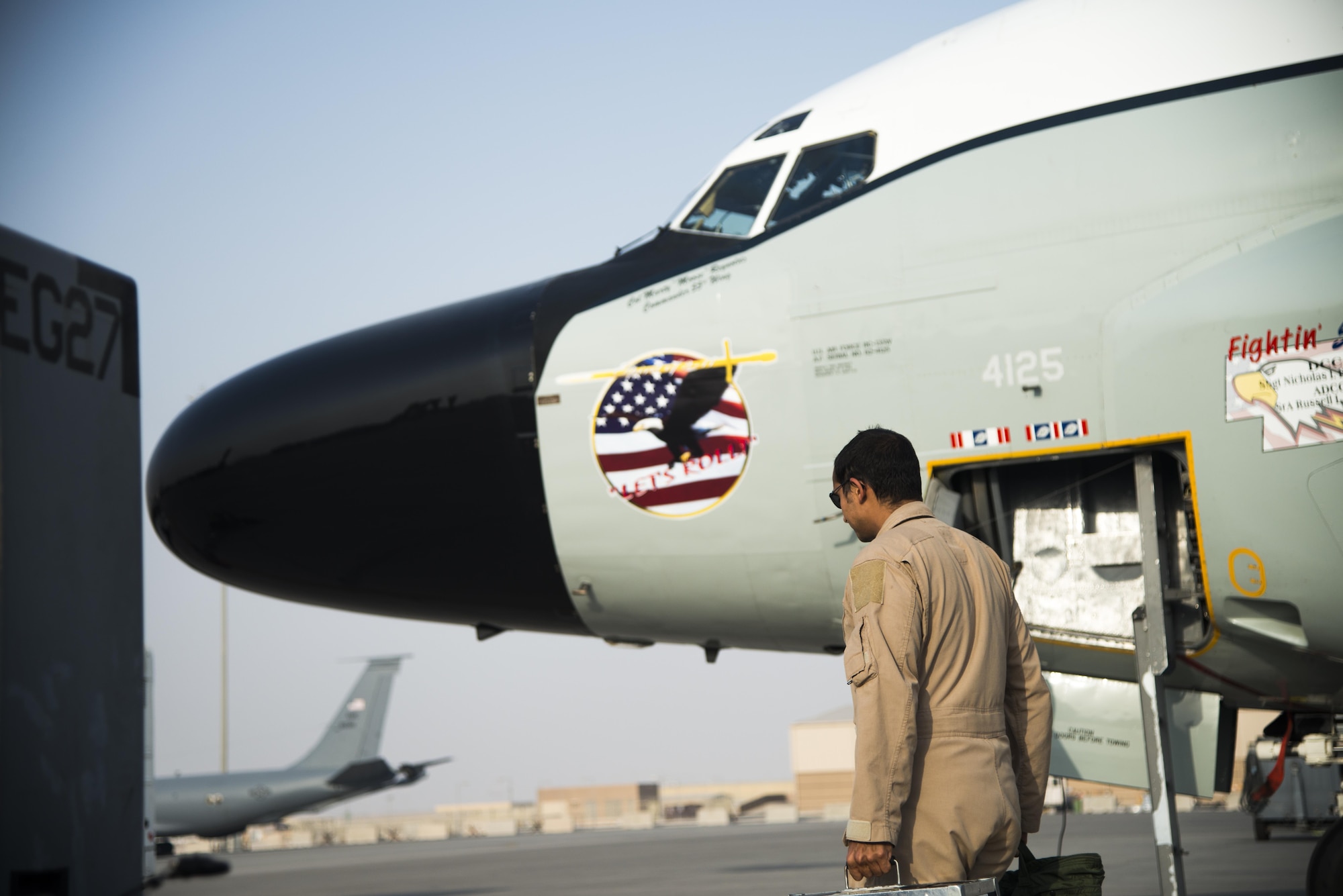 A member from the 763rd Expeditionary Reconnaissance Squadron exits an RC-135 Rivet Joint surveillance aircraft July 24, 2015 at Al Udeid Air Base, Qatar. The RC-135 Rivet Joint aircraft has maintained a constant presence in Southwest Asia since the early 1990s. The aircraft and crew are deployed from Offutt Air Force Base, Neb. in support of Operation Inherent Resolve and Operation Freedom’s Sentinel. (U.S. Air Force photo by Tech. Sgt. Rasheen Douglas)