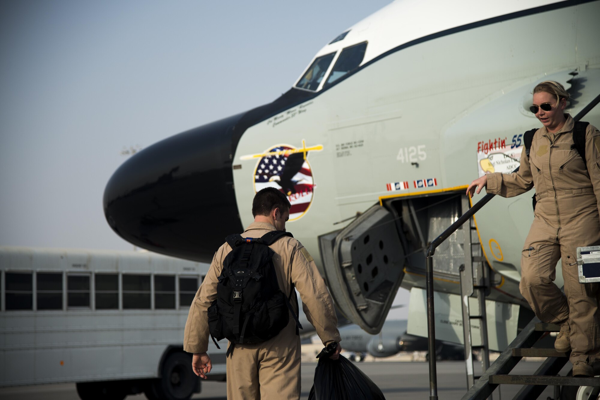 Members from the 763rd Expeditionary Reconnaissance Squadron exit an RC-135 Rivet Joint surveillance aircraft July 24, 2015 at Al Udeid Air Base, Qatar. The RC-135 Rivet Joint aircraft has maintained a constant presence in Southwest Asia since the early 1990s. The aircraft and crew are deployed from Offutt Air Force Base, Neb. in support of Operation Inherent Resolve and Operation Freedom’s Sentinel. (U.S. Air Force photo by Tech. Sgt. Rasheen Douglas)