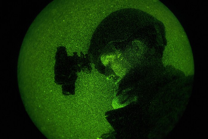U.S. Air Force Senior Airman Troy Leatherman, 439th Civil Engineer Squadron explosive ordnance disposal technician, prepares for a nighttime training mission in support of Patriot Warrior at Fort McCoy, Wis., June 20, 2015. Patriot Warrior is a joint exercise designed to demonstrate contingency deployment training ranging from bare base buildup to full operational capabilities. It supports Exercise Global Lightning, a Combat Support Training Exercise (CSTX) including Global Medic 15 and Quartermaster Liquid Logistics Exercise 15 (QLLEX). Over 6,500 members from U.S. service components including Air Force, Army, and Navy (Active, Guard, and Reserve) participated alongside British and Canadian forces. (U.S. Air Force photo by Tech. Sgt. Joshua J. Garcia/Released)
