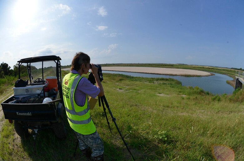 Ellie Covington, a biologist with U.S. Army Corps of Engineers Savannah District, counts birds through a spotting scope at Jones-Oysterbed Island, June 26. The island is one of four created as part of environmental mitigation for the Savannah Harbor Navigation Project and designed to entice threatened species of birds to nest. 