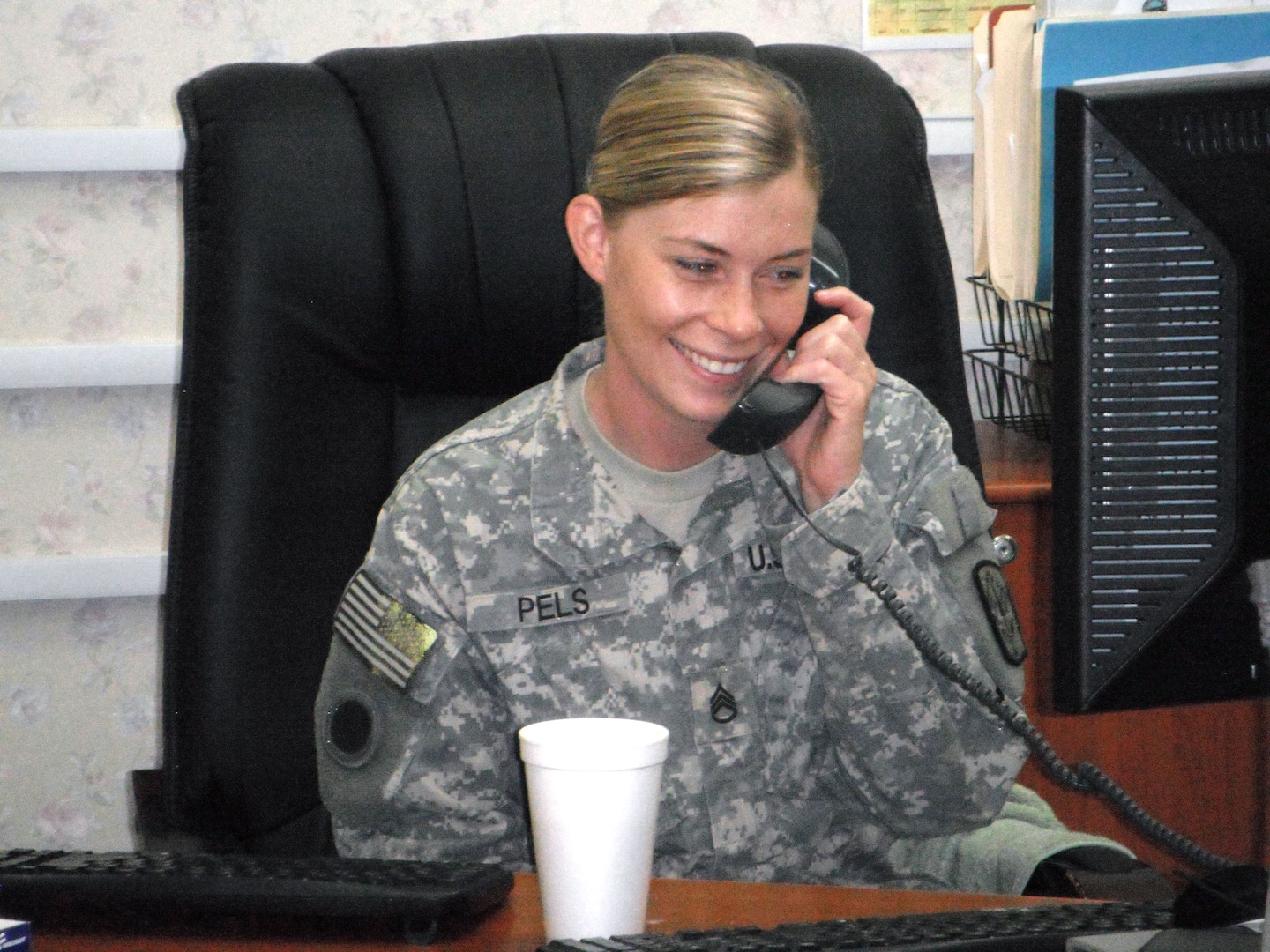 Army Staff Sgt. Kelly Ann Pels, of Cincinnati, with Headquarters and
Headquarters Battery, 1st Battalion, 174th Air Defense Artillery Regiment,
United States Division - Center, receives a call from Secretary of Defense
Leon Panetta, July 4, 2011, at Camp Victory in Baghdad. Pels was one of six
deployed service members the defense secretary called to personally thank
them for their service on Independence Day.