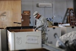 Army Spc. Jose Martinez, with the California National Guard's 640th Aviation
Support Battalion, sorts equipment as he helps with Operation Clean Sweep at
Camp Taji on July 1, 2011.