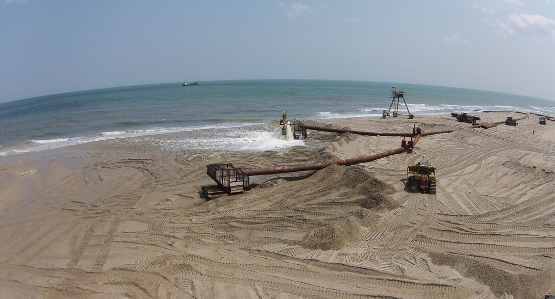 The U.S. Army Corps of Engineers' Philadelphia District and its contractor Great Lakes Dredge & Dock Company are pumping approximately 8 million cubic yards of sand onto Long Beach Island, N.J. The Dredge Dodge Island is shown in the distance. Work is designed to complete the dune and berm system and reduce future storm damages. 