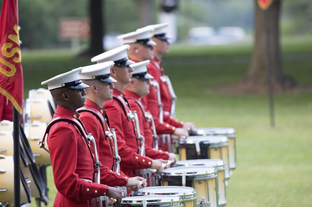 The U.S. Marine Drum and Bugle Corps perform during the Sunset Parade at the Marine Corps War Memorial in Arlington, Va., July 28, 2015. The guest of honor for the Sunset Parade was Admiral Harry Harris Jr., commander, U.S. Pacific Command, and the hosting official was Gen. John Paxton Jr., assistant commandant of the Marine Corps.. (U.S. Marine Corps photo by Cpl. Chi Nguyen/Released)