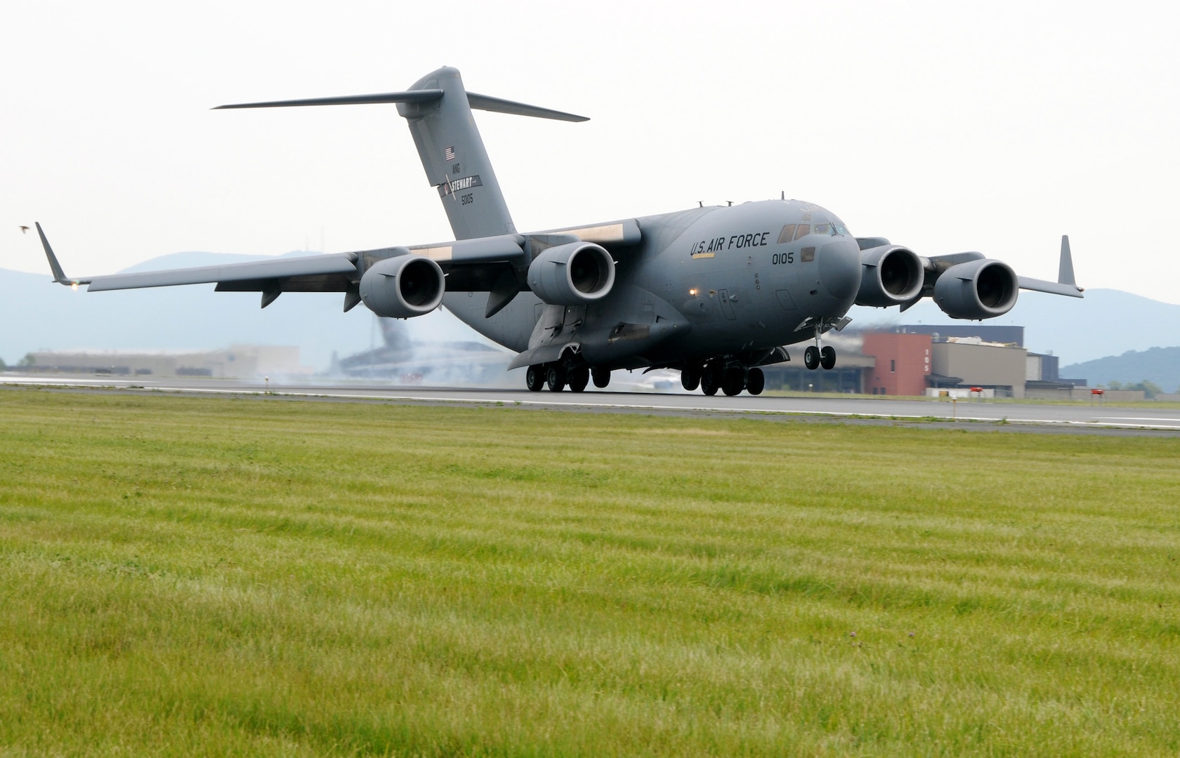 The first C-17 Globemaster III assigned to the 105th Airlift Wing touches down on Stewart International Airport's runway July 18, 2011. It is one of eight C-17s the 105th Wing is scheduled to receive as the unit phases out its C-5A Galaxy aircraft.