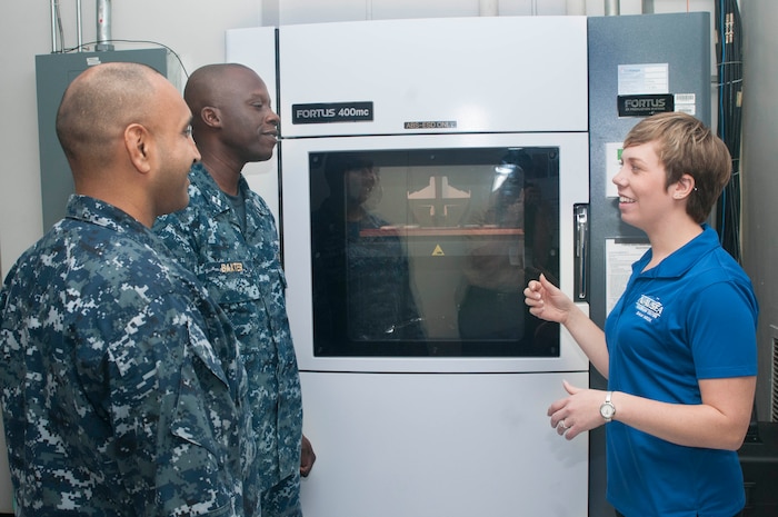 Carolyn Lambeth, a mechanical engineer at Combat Direction Systems Activity, right, explains the process on addictive manufacturing and 3D printing to Sailors during the U.S. Navy's first Maker Faire titled Print the Fleet. The event showcased additive manufacturing techniques for Sailors and other stakeholders attending the two-day event. (U.S. Navy photo by Mass Communication Specialist Seaman Jonathan B. Trejo/ Released)