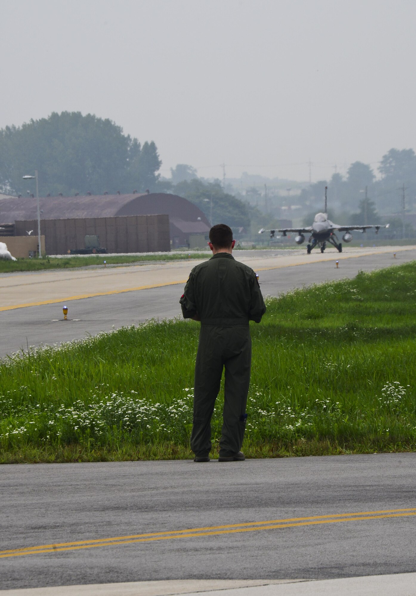 U.S. Air Force Capt. Ely Smith, 36th Fighter Squadron scheduling officer and flight lead, watches as an F-16C “Fighting Falcon” prepares to take-off on Osan Air Base, South Korea, July 22, 2015. In the past year, the squadron has flown more than 4,500 sorties, giving the 36th the largest F-16 flying program in the Combat Air Force. (U.S. Air Force photo by Senior Airman Kristin High/Released)