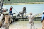 Texas Army National Guard Soldiers attach an improved ribbon bridge bay to the M1977 common boat transporter while conducting IRB operations during Operator New Equipment Training. The Soldiers are assigned to the 551st Multi-Role Bridge Company, 386th Engineer Battalion, 176th Engineer Brigade