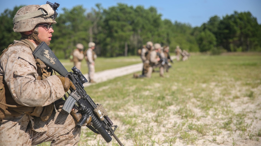 Lance Cpl. Joe Escobedo, a rifleman with Golf Company, 2nd Battalion, 2nd Marine Regiment, looks toward a target after conducting a squad attack aboard Camp Lejeune, N.C., July 28. The training incorporated multiple weapon systems, including the M16A4 service rifle, M203 grenade launcher, Shoulder-launched Multipurpose Assault Weapon and M249 Squad Automatic Weapon to help increase interoperability between weapons in training operations. (