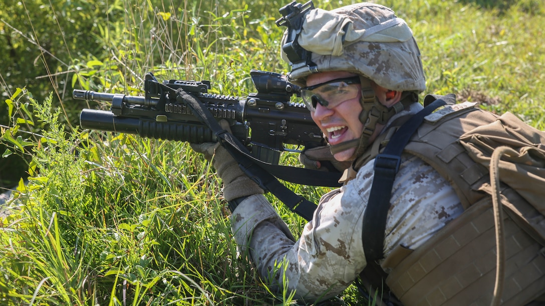 Corporal Justin Burgos, a mortar man with Golf Company, 2nd Battalion, 2nd Marine Regiment, passes on instructions during a squad attack aboard Camp Lejeune, N.C., July 28. Burgos was one of approximately 50 Marines with the unit to participate in the training, which was designed to prepare them for an upcoming deployment with the Unit Deployment Program. 