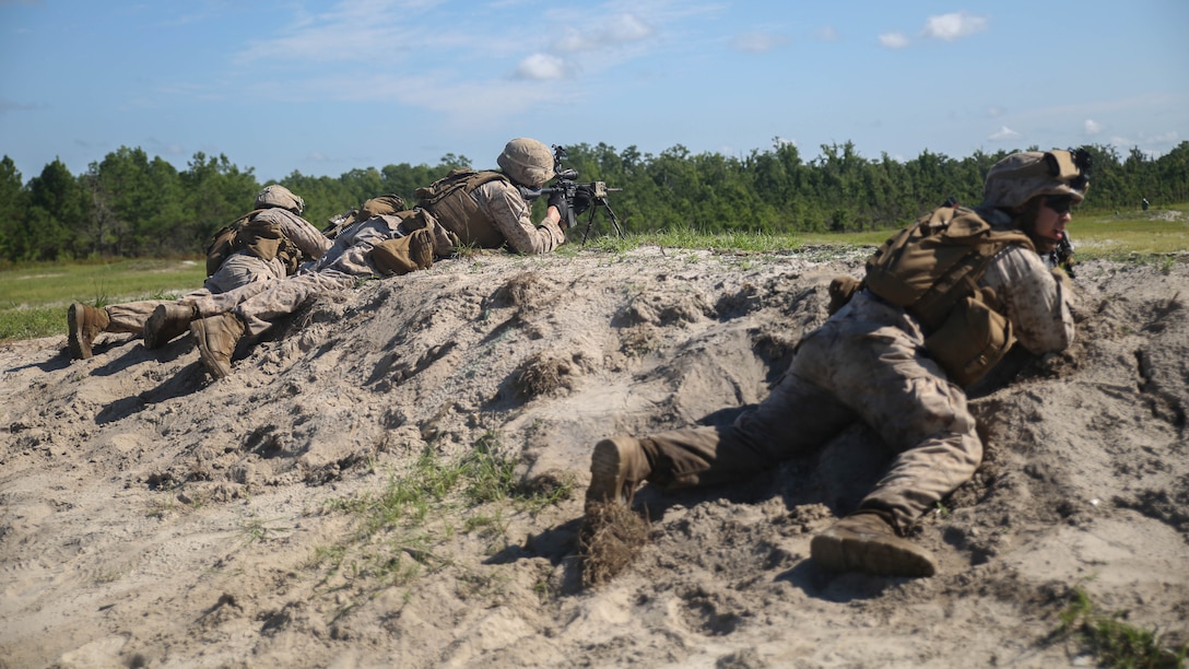 Marines with Golf Company, 2nd Battalion, 2nd Marine Regiment, fire toward a target during a squad attack range aboard Camp Lejeune, N.C., July 28. Approximately 50 Marines with the unit participated in the training, which helped build unit cohesion and fire and maneuver skills. 