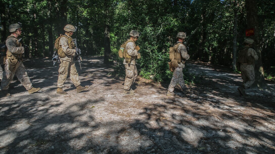 U.S. Marines with Golf Company, 2nd Battalion, 2nd Marine Regiment, make their way toward an objective before conducting a squad attack exercise aboard Camp Lejeune, N.C., July 28. Approximately 50 Marines with the unit participated in the training, which helped build unit cohesion and fire and maneuver skills.
