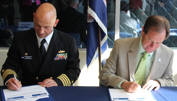 NORFOLK, Va. - Naval Surface Warfare Center Dahlgren Division Commander Capt. Brian Durant and Old Dominion University President Dr. John Broderick sign a memorandum of understanding at ODU Oct. 28. In addition to the memorandum of understanding – which defines the engagement field of a maturing NSWCDD-ODU relationship - they signed education partnership and non-disclosure agreements to expand collaboration benefitting Navy technology programs as well as the university's students and faculty.