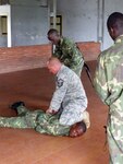 Air Force Master Sgt. Todd Agans, a member of the 183rd Security Forces Squadron, Illinois National Guard, shows members of the Suriname army proper techniques for handcuffing detainees in Paramaribo, Suriname July 8, 2011. This training is part of exercise New Horizons Suriname 2011. Over 600 U.S. military personnel and 50 Surinamese military personnel will participate in the exercise at various times over a three month period.