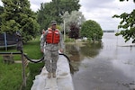 Army Spc. Sterling Klein, a Soldier with Detachment 2, 191st Military Police Company, North Dakota National Guard, patrols a dike on the south side of Mandan, N.D., July 16, 2011 – a day where the temperature hovered in the mid-90s. The North Dakota National Guard is patrolling dikes in the Bismarck and Mandan area 24/7.