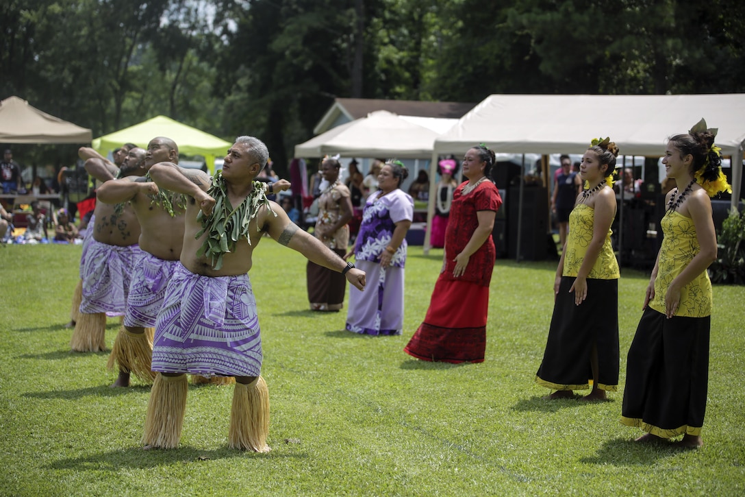 Tavita Saelua, a Master Chief in the Navy, who volunteers as  one of the committee leaders that organizes and runs the festival each year, dances with a group to a traditional Polynesian song during the North Carolina Polynesian Festival at Onslow Pines Park, N.C., July 24-25, 2015.  Marines, sailors and their family members volunteered and attended the annual Polynesian Festival, hosted by Onslow County, which included an introduction to the many islands that make up the Polynesian area and showcased the culture and heritage of each.  (U.S. Marine Corps photo by Cpl. Alexander Mitchell/Released)