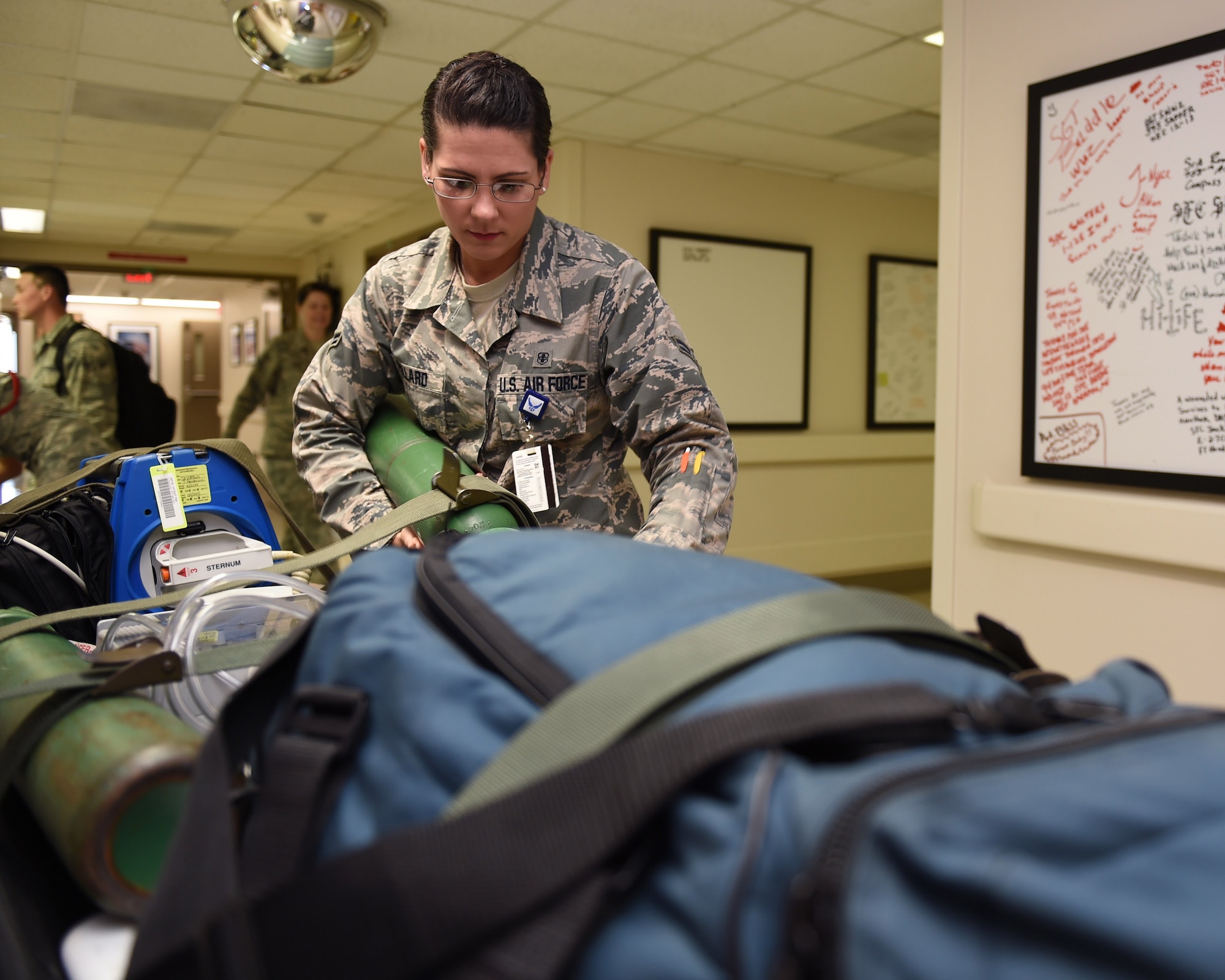 Airman 1st Class Megan Pollard prepares supplies for an incoming aeromedical evacuation flight at the Wilford Hall Ambulatory Surgical Center, Joint Base San Antonio-Lackland, Texas, July 23, 2015. Pollard is part of a 12-person team assigned to the 559th En-Route Patient Staging System that serves as the Midwest aeromedical evacuation hub for wounded warriors transiting back home or here for specialty care. (U.S. Air Force photo by Staff Sgt. Jerilyn Quintanilla)