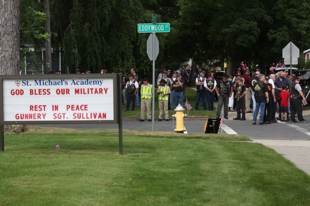 SPRINGFIELD, Mass.  – Family and friends of Gunnery Sgt. Thomas J. Sullivan line the streets outside Holy Cross Church in Springfield, Massachusetts, July 27, 2015 during funeral services for Sullivan, who was one of five victims of the Chattanooga, Tennessee shootings July 16, 2015. Along with friends and family, hundreds lined the route of the funeral procession to pay their respects. (U.S. Marine Corps photo by Cpl. J. Gage Karwick/Released) 