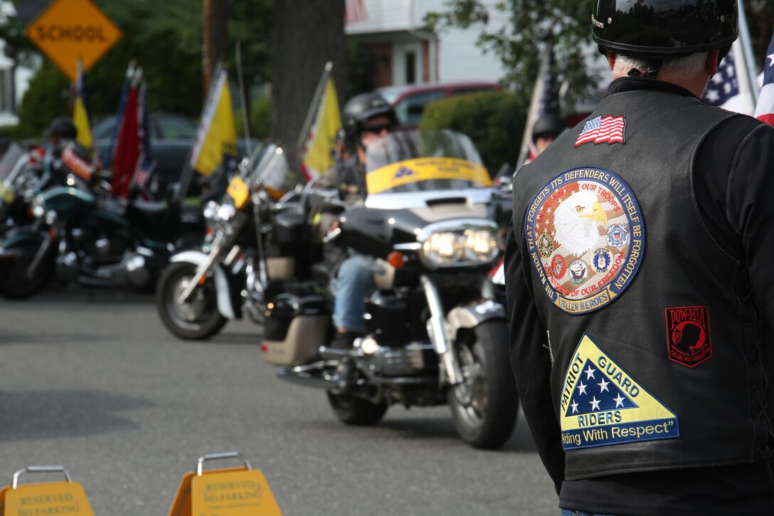 SPRINGFIELD, Mass. – Members of the Patriot Guard Riders motorcycle club line the streets for Gunnery Sgt. Thomas J. Sullivan’s funeral procession outside Holy Cross Church in Springfield, Massachusetts, July 27, 2015. Sullivan was one of five victims of the Chattanooga, Tennessee shootings July 16, 2015. The Patriot Guard led the way in the procession with more than 100 riders bearing American and Marine Corps flags to honor the fallen hero. (U.S. Marine Corps photo by Cpl. J. Gage Karwick/Released)