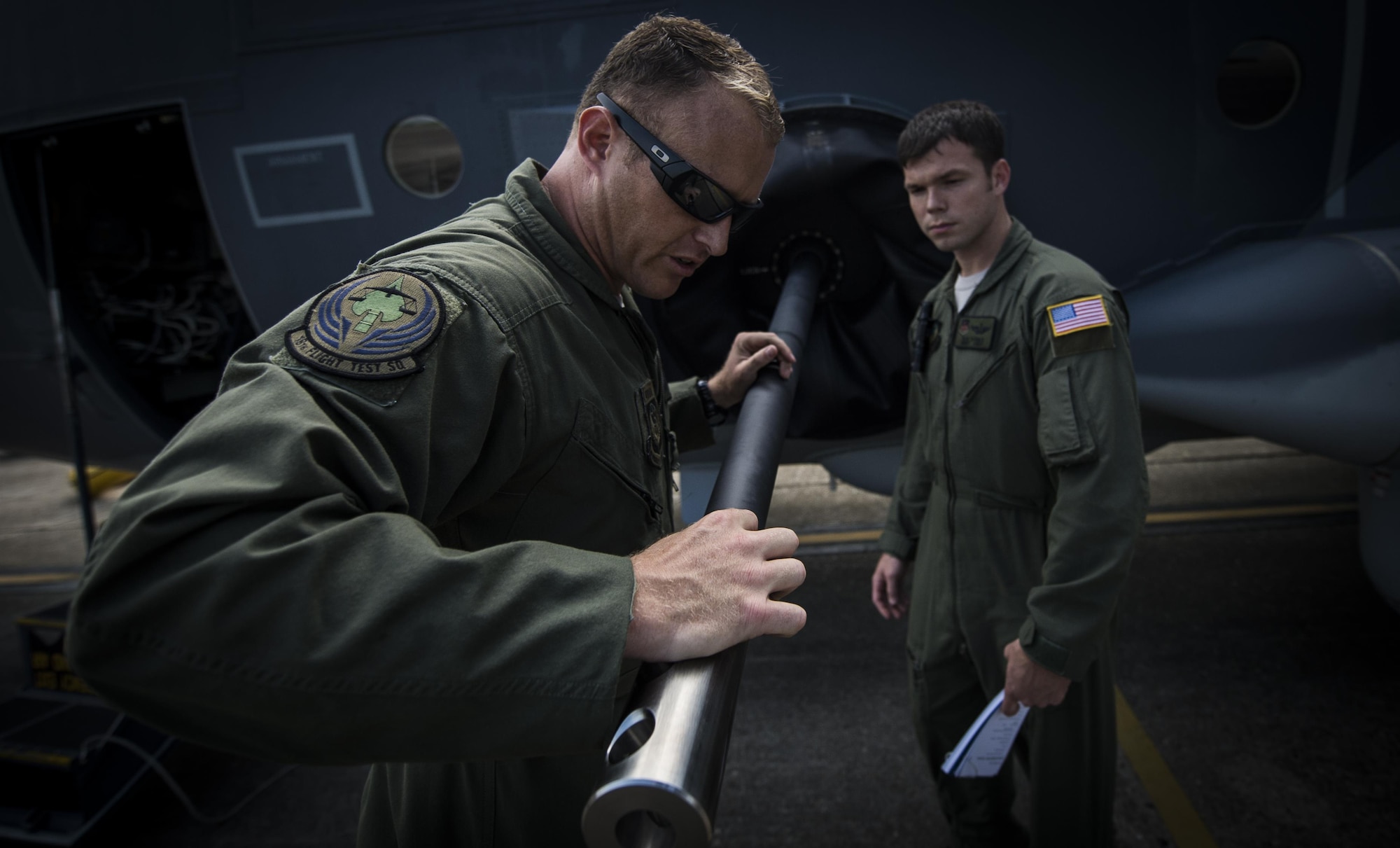 Master Sgt. James Knight left, 18th Flight Test Squadron aerial gunner, performs a pre-flight inspection with Staff Sgt. Rob Turner right, 1st Special Operations Group Detachment 2 aerial gunner, on Eglin Air Force Base, Fla., July 29, 2015. The aircrews of the 1st SOG Det. 2 were hand selected from the AC-130 community for their operational expertise and will begin initial operational testing and evaluation of the AC-130J later this year. (U.S. Air Force photo/Senior Airman Christopher Callaway)