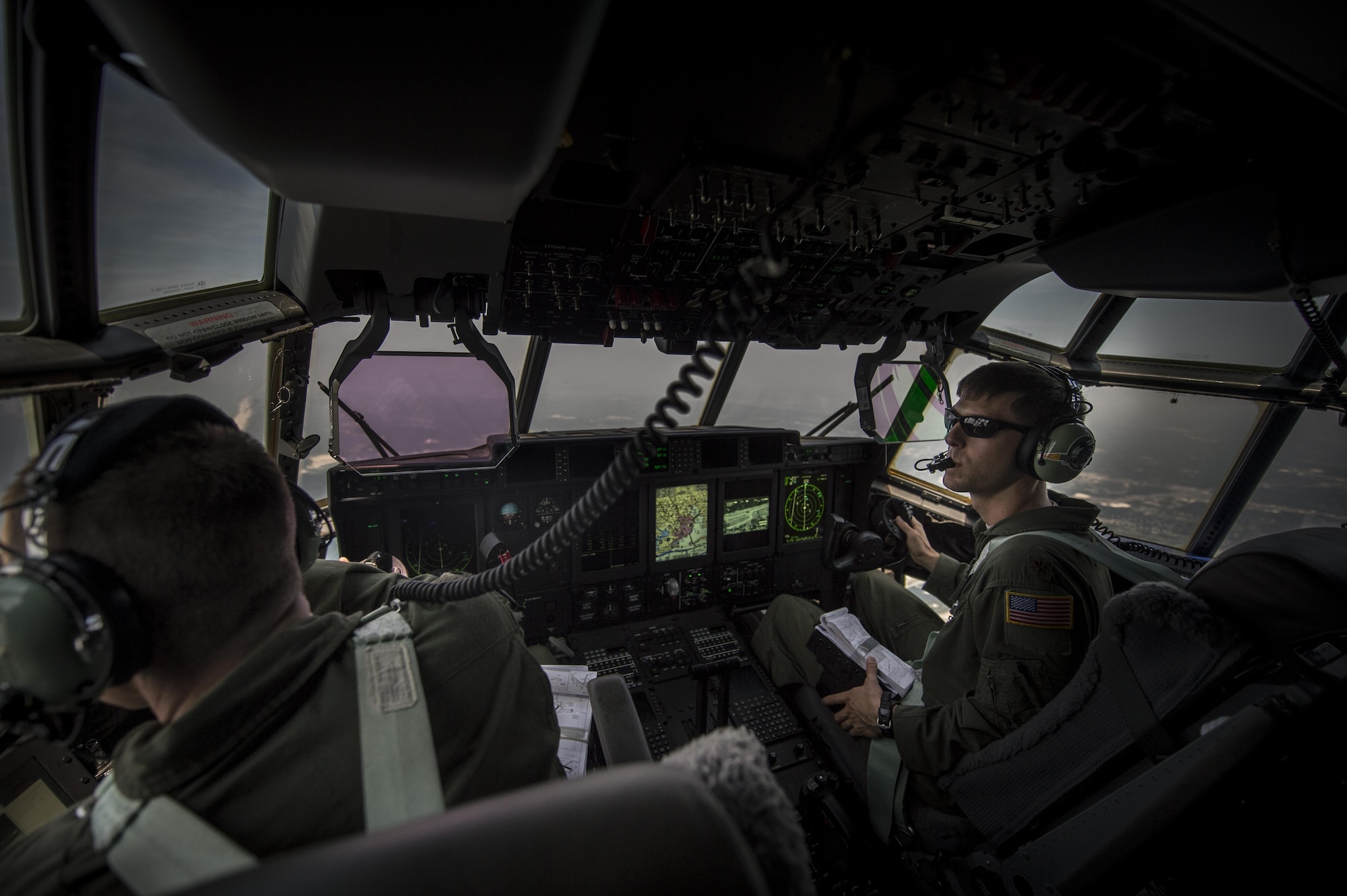 Maj. Brian Pesta right, 1st Special Operations Group Detachment 2 pilot (right) and Maj. Jason Fox left, 18th Flight Test Squadron pilot, look out the left window during the delivery flight of Air Force Special Operations Command’s first AC-130J Ghostrider to the 1st Special Operations Wing on Hurlburt Field, Fla., July 29, 2015. The AC-130J recently completed its initial developmental test and evaluation at Eglin Air Force Base, Fla., and will begin initial operational test and evaluation under aircrews of the 1st SOG Det. 2 and 1st Special Operations Aircraft Maintenance Squadron later this year. (U.S. Air Force photo/Senior Airman Christopher Callaway)