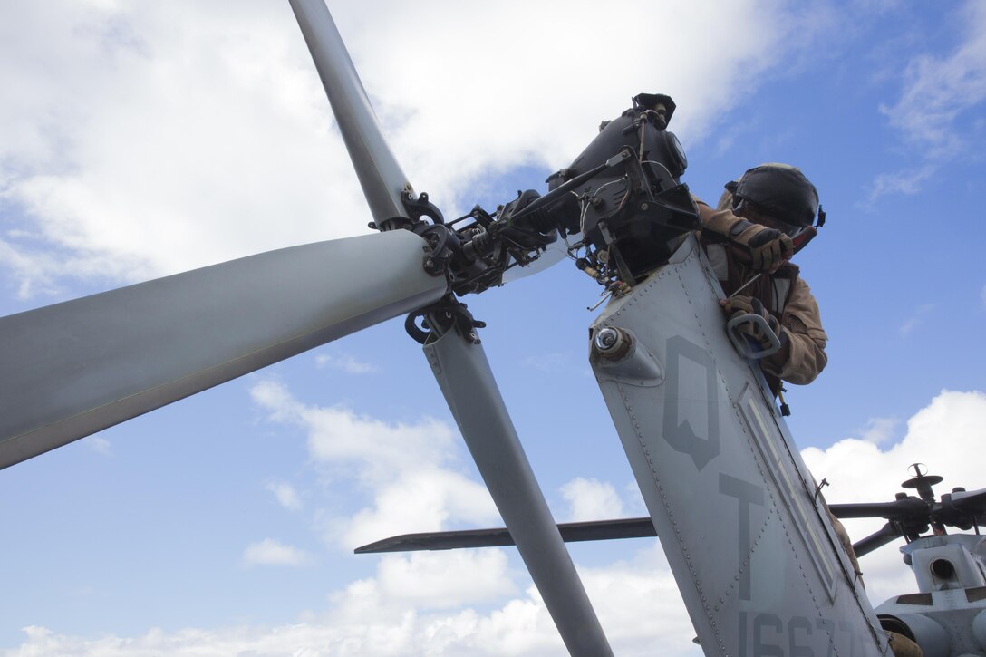 Capt. Brian Jordan, a UH-1Y Huey pilot with Marine Light Attack Helicopter Training Squadron (HMLAT) 303, and a Corpus Christi, Texas native, performs maintenance on a UH-1Y Huey aboard the USS Boxer, July 26. Marines with the 3rd Marine Aircraft Wing prepared the aircraft for the 2015 Seattle Seafair. (U.S. Marine Corps photo by Sgt. Lillian Stephens/Released)