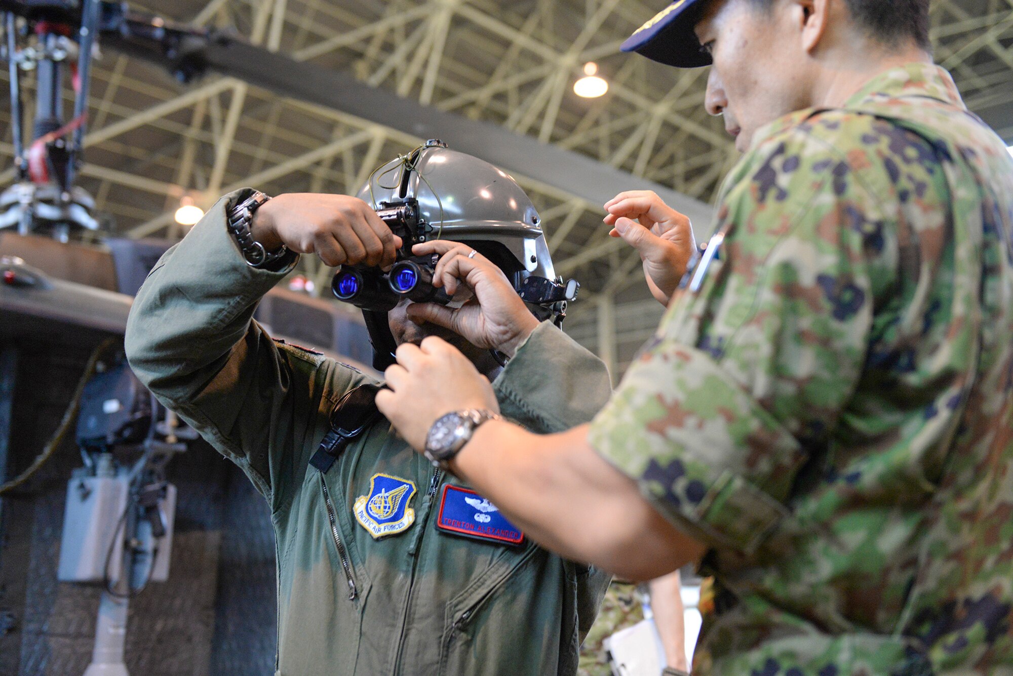 U.S. Air Force Lt. Col Trenton Alexander, 459th Airlift Squadron director of operations, tries on head gear at Tachikawa Air Base, Japan, July 16, 2015. The tour enhanced the US-Japan bilateral relationship, which is essential to the stability in Indo-Asia-Pacific region. (U.S. Air Force photo by Airman 1st Class Elizabeth Baker/Released)