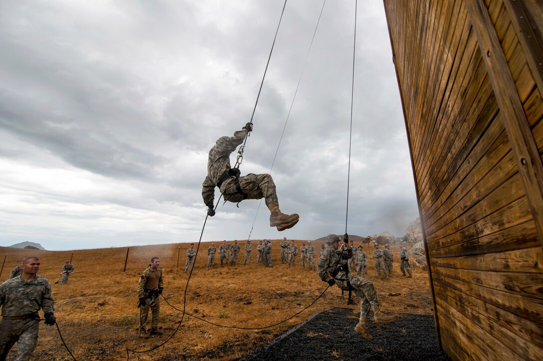 Soldiers rappel from a 100-foot tower during a sapper leader course on Camp San Luis Obispo in San Luis Obispo County, Calif., July 19, 2015. 