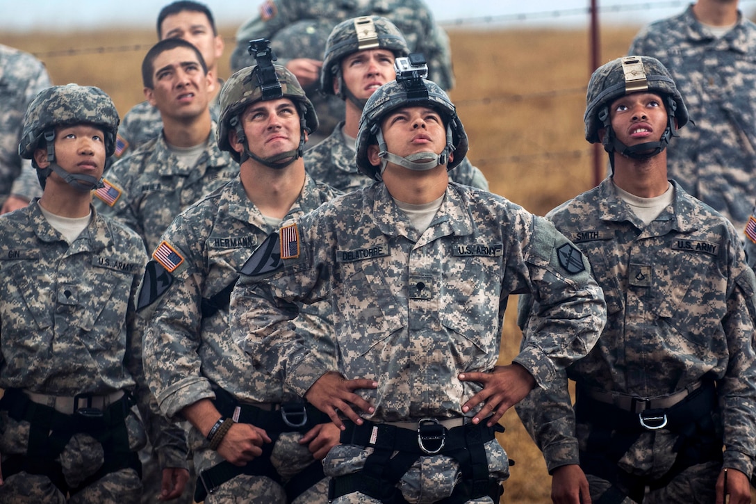 Soldiers watch team members rappel from a 100-foot tower during a sapper leader course on Camp San Luis Obispo in San Luis Obispo County, Calif., July 19, 2015.