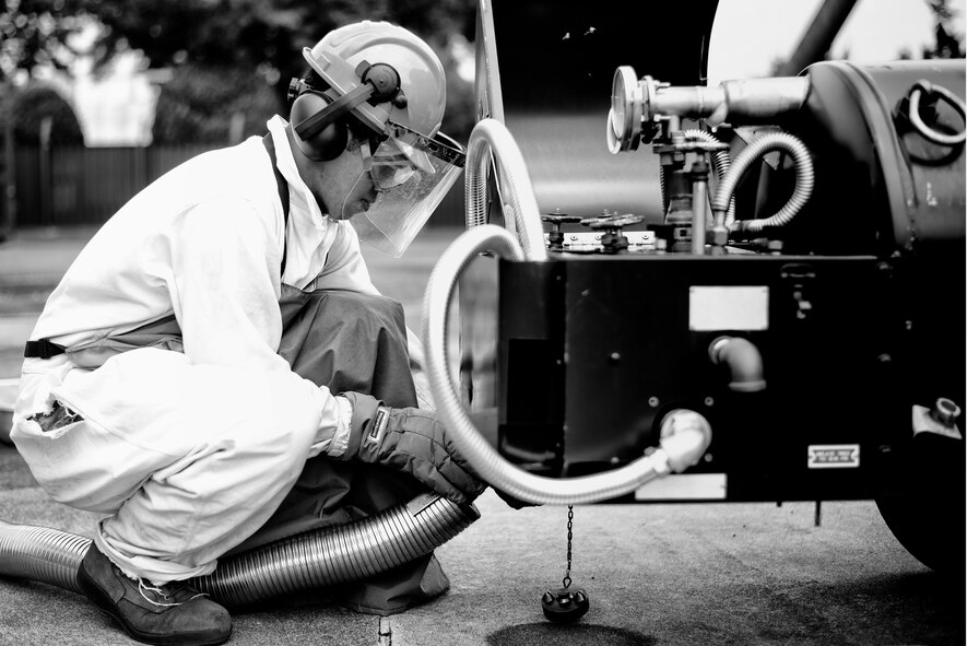 Senior Airman Christopher Benavente, 374th Logistics Readiness Squadron cryogenic technician, attaches a hose carrying liquid oxygen to a LOX tank July 29, 2015, at Yokota Air Base, Japan. The LRS cryogenics lab supplies the 374th Aircraft Maintenance Squadron and the 730th Air Mobility Squadron with their LOX and liquid nitrogen needs. (U.S. Air Force photo by Airman 1st Class Delano Scott/Released)