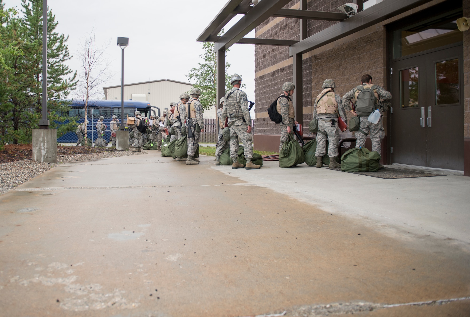 U.S. Air Force Airmen from the 354th Fighter Wing file into the Stevens Joint Mobility Complex, July 28, 2015, at Eielson Air Force Base, Alaska. The wing tested unit deployment techniques including weapons issue, medical readiness and movement of baggage during an operational readiness exercise. (U.S. Air Force photo by Staff Sgt. Shawn Nickel/Released)

