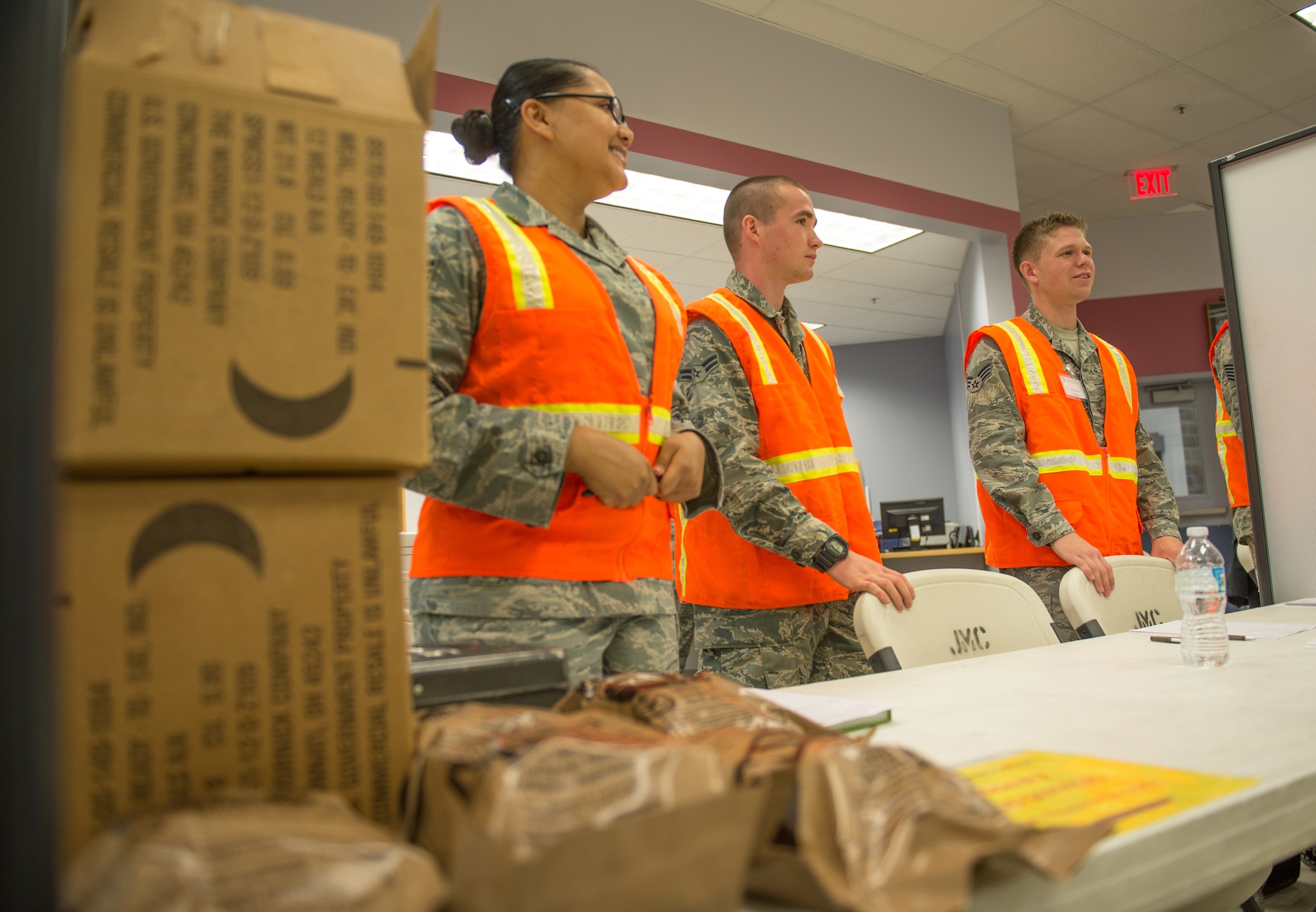 U.S. Air Force Airmen provide services in a pre-deployment briefing line to expedite processing during a simulated mass deployment July 28, 2015, at Eielson Air Force Base, Alaska. The deployment was part of an operational readiness exercise, which tests the base’s response to situations such as short-notice-deployments or disasters. (U.S. Air Force photo by Staff Sgt. Shawn Nickel/Released)