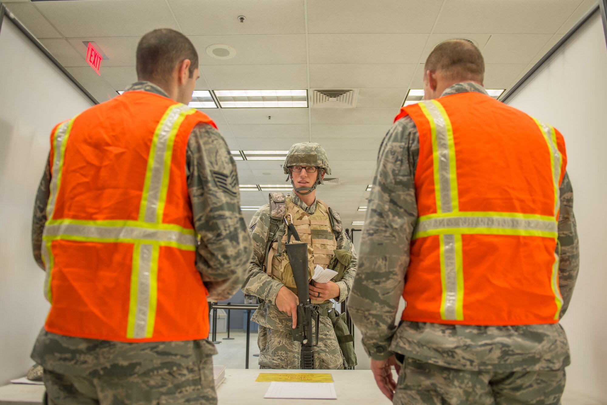 U.S. Air Force Airmen provide services in a pre-deployment briefing line to expedite processing during a simulated mass deployment July 28, 2015, at Eielson Air Force Base, Alaska. The deployment was part of an operational readiness exercise, which tests the base’s response to situations such as short-notice-deployments or disasters. (U.S. Air Force photo by Staff Sgt. Shawn Nickel/Released)