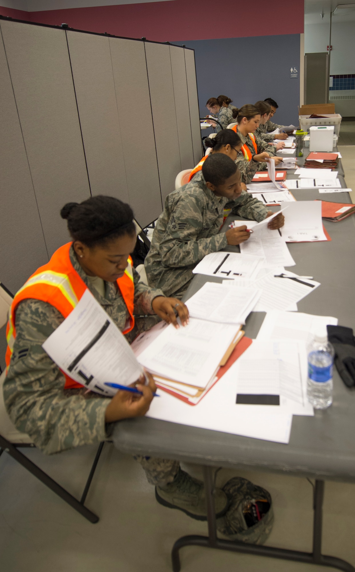 U.S. Air Force Airmen from the 354th Force Support Squadron military personnel section sort through deployment folders for more than a hundred Airmen simulating a mass deployment during an operational readiness exercise (ORE) July 28, 2015, at Eielson Air Force Base, Alaska. OREs test the base’s response to situations such as short-notice-deployments or disasters. (U.S. Air Force photo by Staff Sgt. Shawn Nickel/Released)
