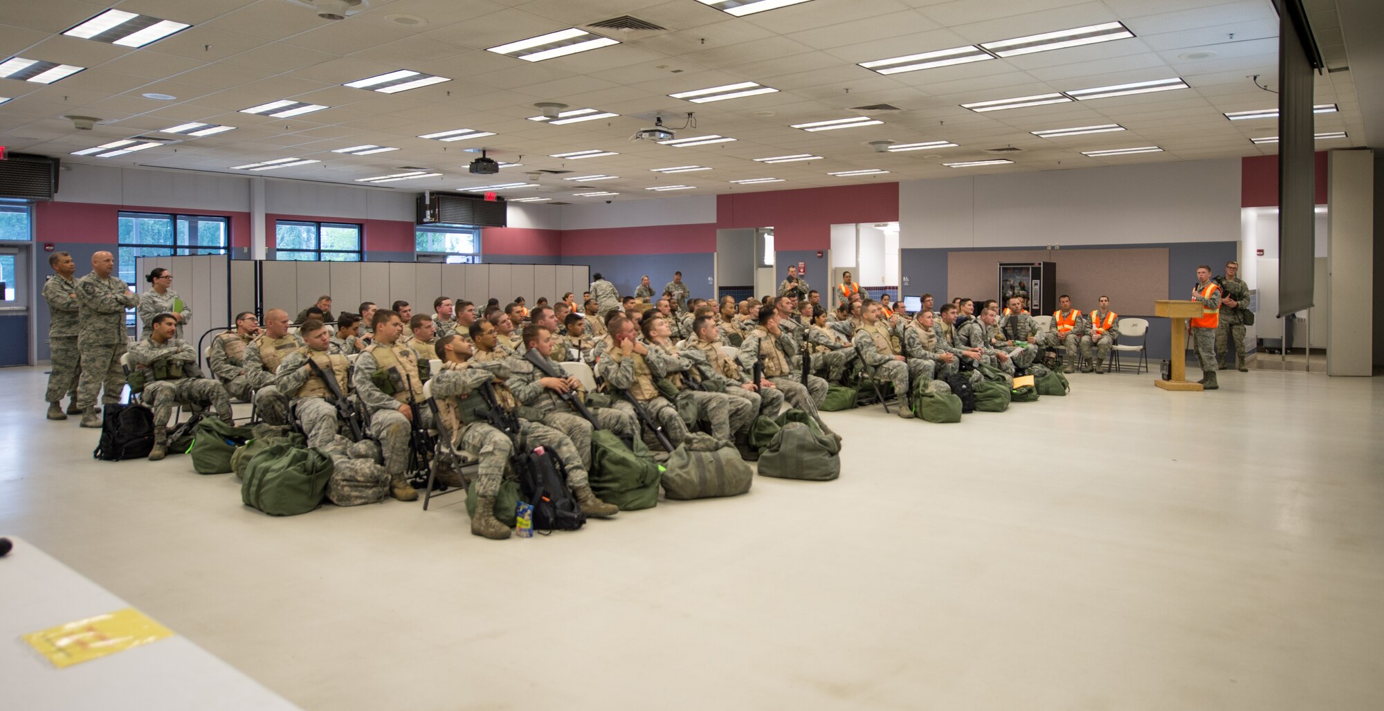 U.S. Air Force Airman 1st Class Alex Westing (far right), a 354th Comptroller Squadron customer service technician, briefs a group of Airmen simulating a mass deployment during an operational readiness exercise (ORE) July 28, 2015, at Eielson Air Force Base, Alaska. OREs test the base’s response to situations such as short-notice-deployments or disasters. (U.S. Air Force photo by Staff Sgt. Shawn Nickel/Released)