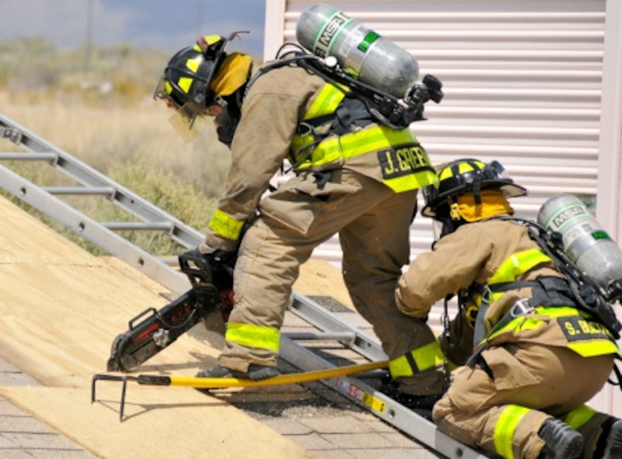 Firefighters from 306th Firefighting Detachment provide ventilation through a roof as part of the unit's mission readiness exercise held recently at Holloman Air Force Base, N.M. (U.S. Army photo by Capt. Jennie Armstrong, 5th Armored Brigade, Division West)