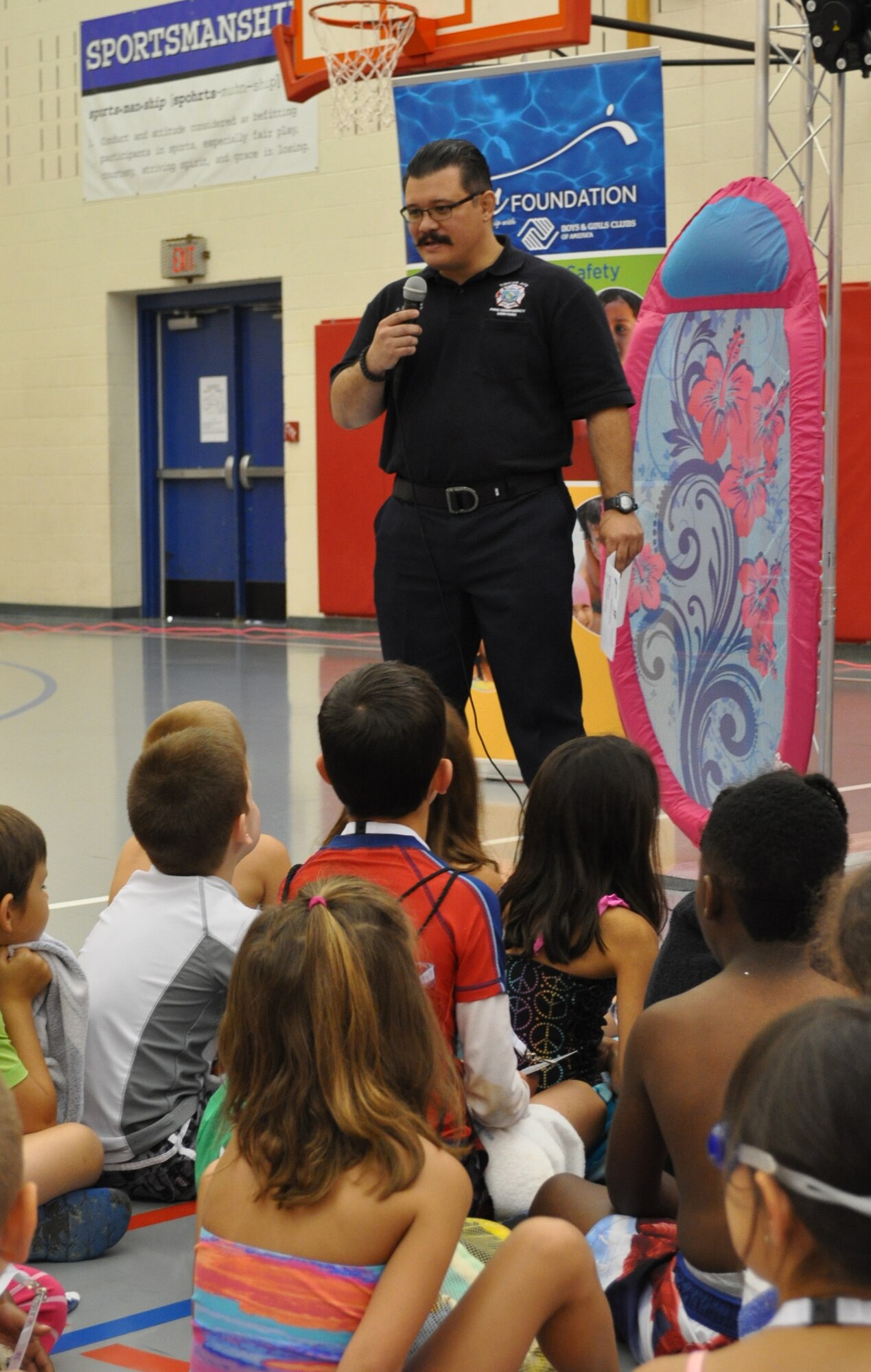 Lt. Aaron Dodson, with Tinker Fire and Emergency Services, speaks to children attending ZAC Camp at the Tinker Youth Center July 20. Getting out and about in the Tinker community and attending events such as the water safety camp at the youth center is a part of the mission of Station 4 firefighters. (Air Force photo by Kimberly Woodruff/Released)