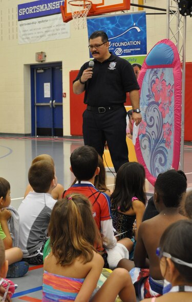 Lt. Aaron Dodson, with Tinker Fire and Emergency Services, speaks to children attending ZAC Camp at the Tinker Youth Center July 20. Getting out and about in the Tinker community and attending events such as the water safety camp at the youth center is a part of the mission of Station 4 firefighters. (Air Force photo by Kimberly Woodruff/Released)