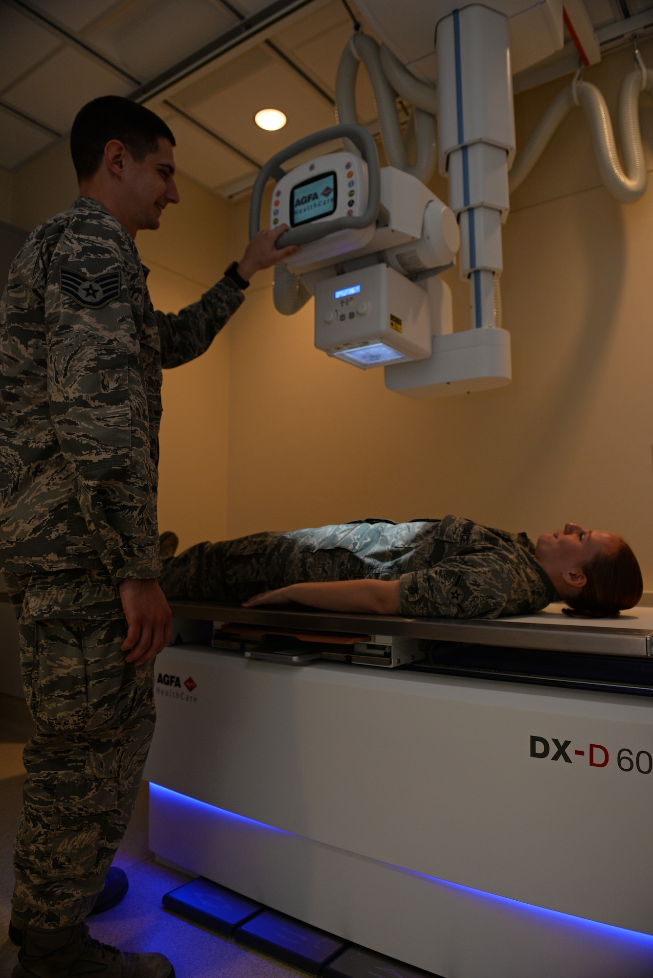 Staff Sgt. Justin Keune, 375th Medical Support Squadron Picture Archive Communication System Administrator, positions a patient on an X-Ray machine, Scott Air Force Base, July 20, 2015. Keune processes an average of 45 patient records a day. (U.S. Air Force photo by Airman 1st Class Erica Holbert-Siebert)