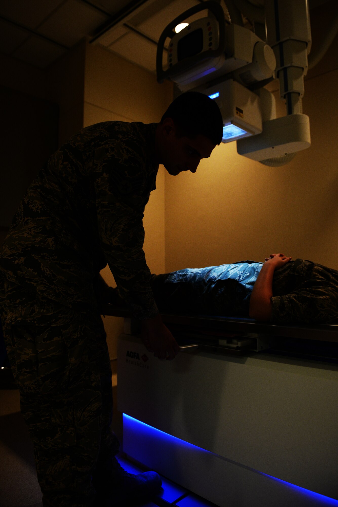 Staff Sgt. Justin Keune, 375th Medical Support Squadron Picture Archive Communication System Administrator, positions a patient on an X-Ray machine, Scott Air Force Base, July 20, 2015. Keune processes an average of 45 patient records a day. (U.S. Air Force photo by Airman 1st Class Erica Holbert-Siebert)
