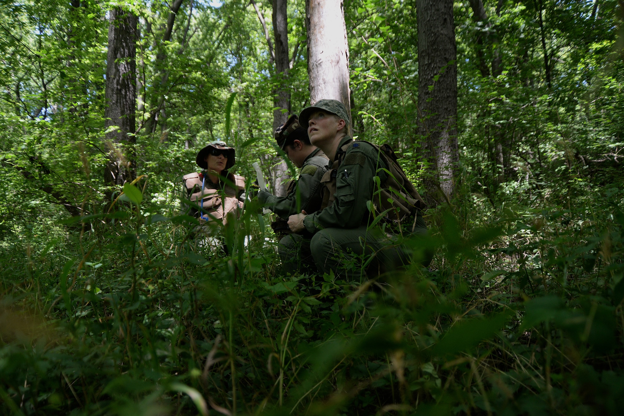 Participants of the combat survival training portion of the Survival, Evasion, Resistance, and Escape, or SERE, training hide while trying to retrieve coordinates during a field exercise July 14, 2015, at Sparta, Ill. Scott Air Force Base has a team of specialists that teach pilots and aircrew SERE techniques each month. The training is split up into two portions: combat survival training and water survival training. (U.S. Air Force photo/Senior Airman Jake Eckhardt)
