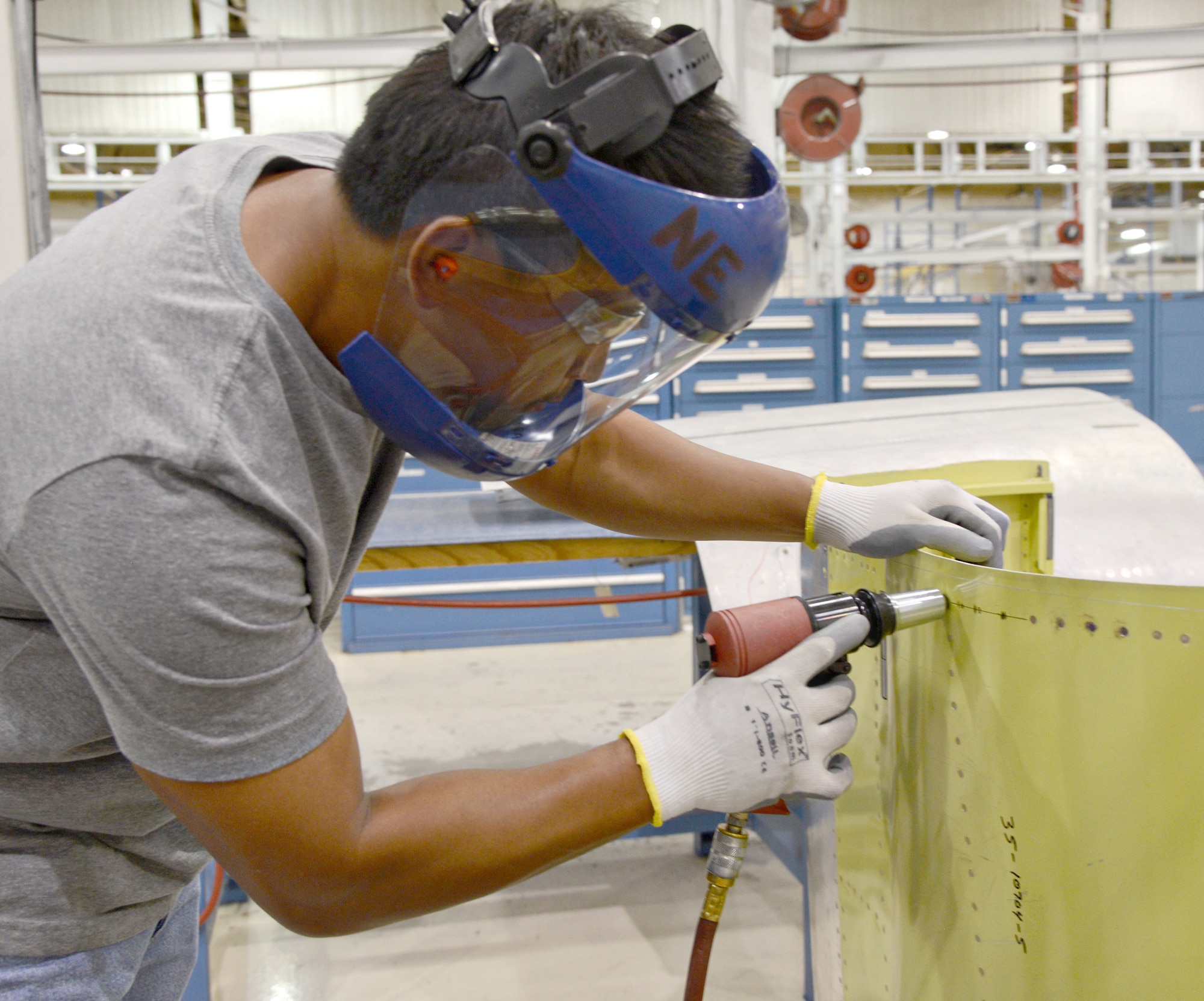 Brandon Sundara, a sheetmetal mechanic in the B-52 Wrap Cowls shop, performs a skin install as part of Module No. 3. (Air Force photo by Kelly White/Released)
