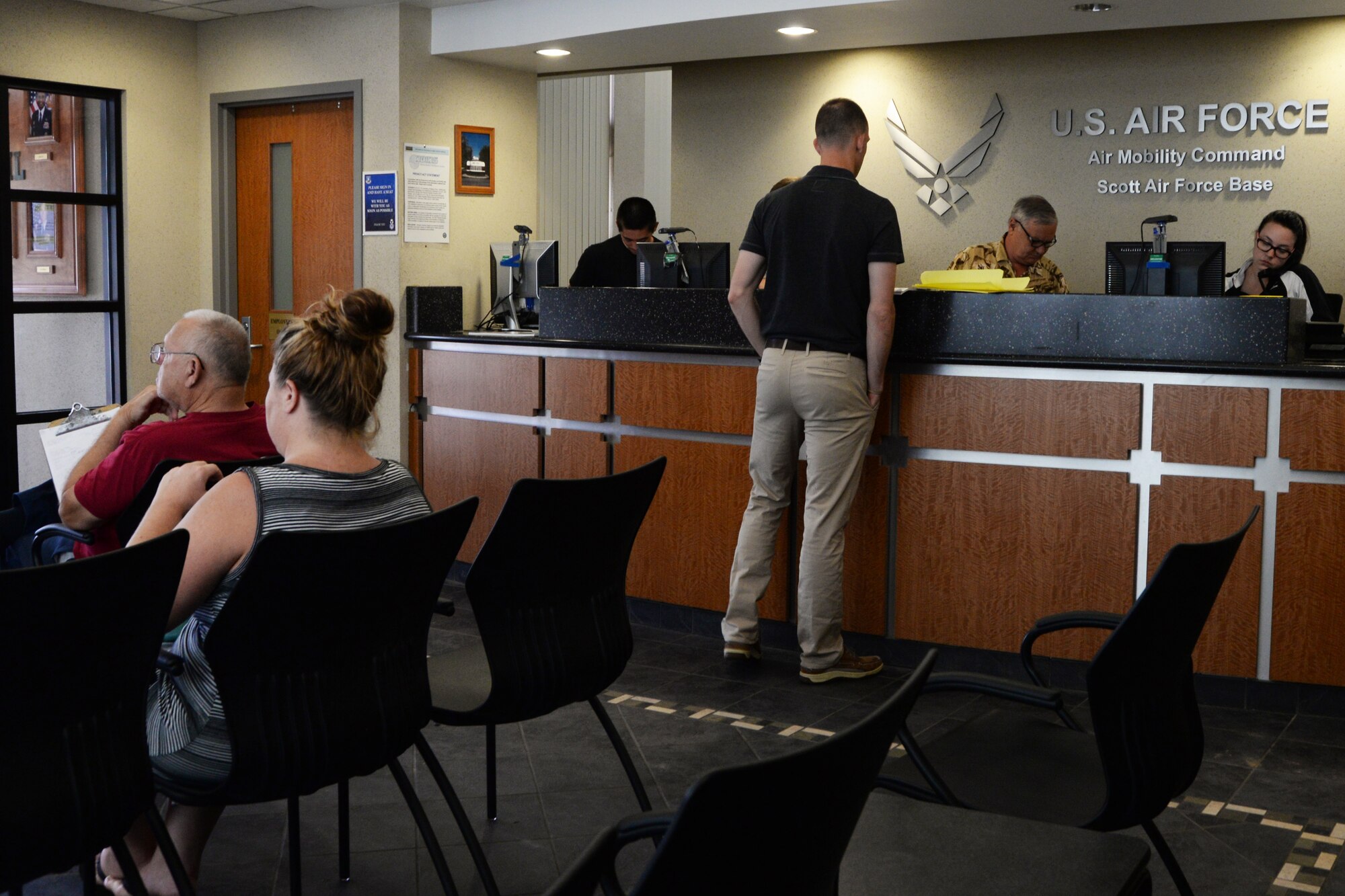 Guests at the Visitor Control Center wait in line for passes on to base, July 21, 2015, at Scott Air Force Base, Ill. Members who use the online method to receive sponsorship will be able to gain base access without waiting. (U.S. Air Force photo by Airman 1st Class Melissa Estevez)