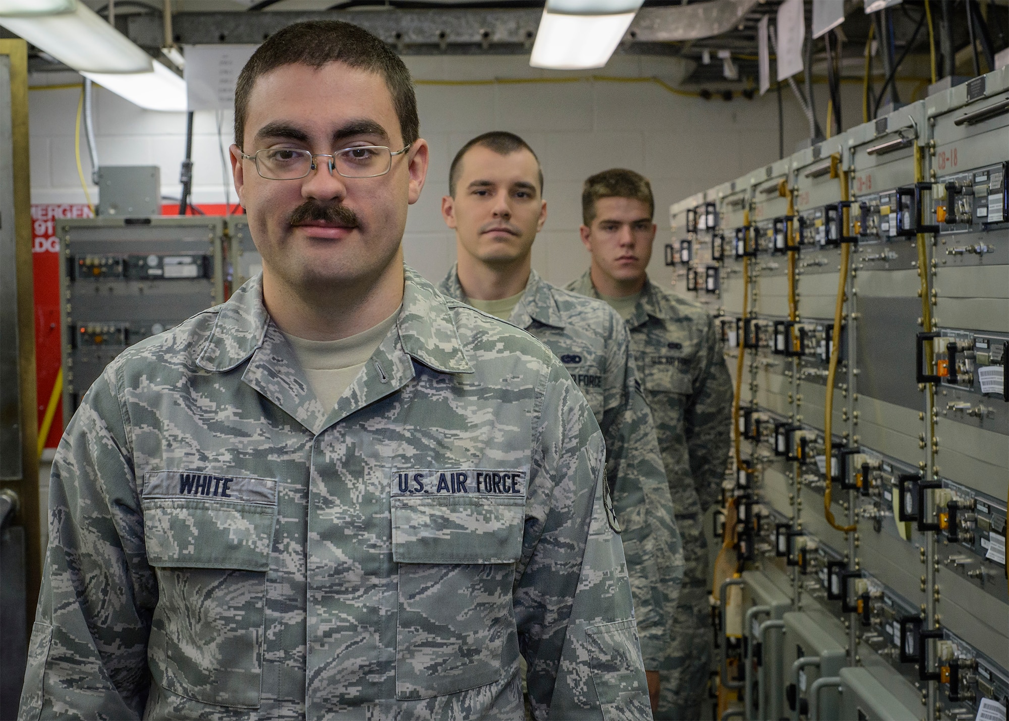 Senior Airman Thomas White, a 71st Operations Support Squadron airfield systems maintainer, and some of his wingmen at the Airfield Systems Maintenance shop at Vance Air Force Base, Oklahoma, June 25. (U.S. Air Force photo / David Poe)