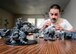 Senior Airman Thomas White, a 71st Operations Support Squadron airfield systems maintainer, enjoys some downtime as he customizes Warhammer 40,000 units at his home in Enid, Oklahoma, June 16. (U.S. Air Force photo / David Poe)